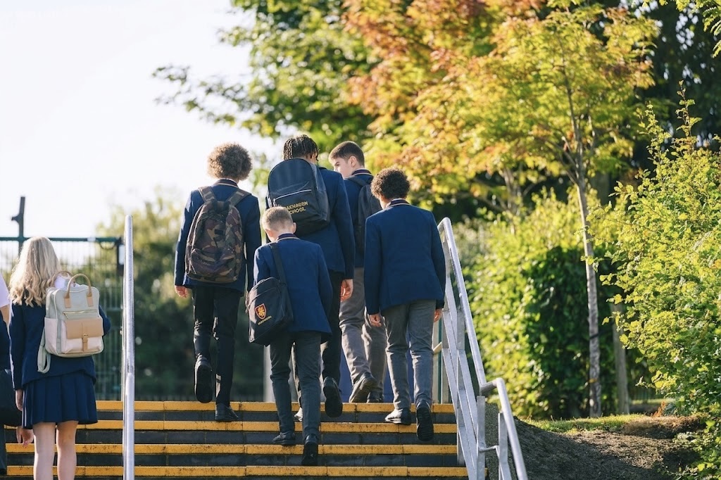 School security personnel standing with students outdoors